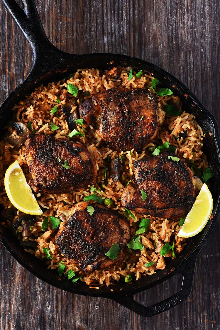 One Pan Spanish Rice & Chicken - Chicken marinated in a delicious rub is seared beautifully & rice infused with so much flavor, so delicious that you won't stop eating.