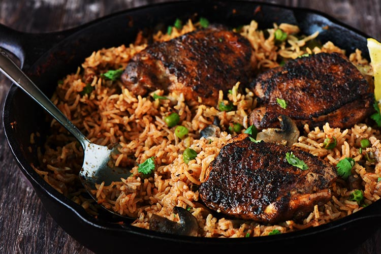 One Pan Spanish Rice & Chicken - Chicken marinated in a delicious rub is seared beautifully & rice infused with so much flavor, so delicious that you won't stop eating.