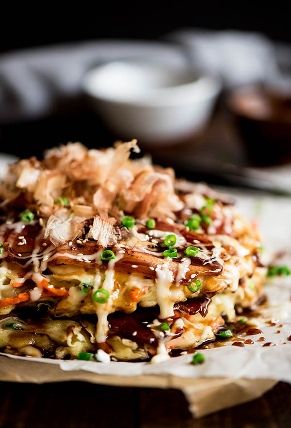 Delightful savory Japanese pancakes made from an easy to make batter, cabbage and bacon topped with Japanese mayo and okonomiyaki sauce.