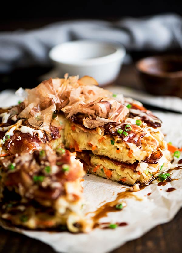 Delightful savory Japanese pancakes made from an easy to make batter, cabbage and bacon topped with Japanese mayo and okonomiyaki sauce.