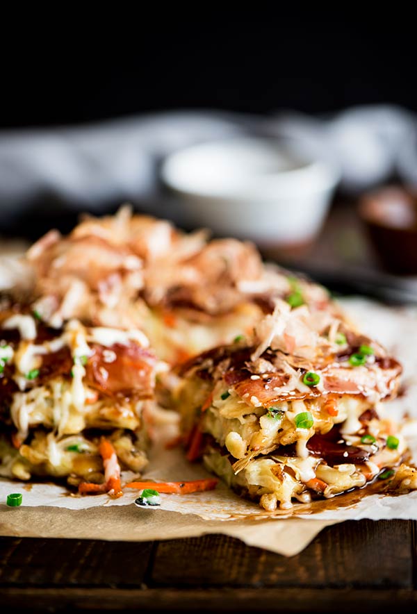 Delightful savory Japanese pancakes made from an easy to make batter, cabbage and bacon topped with Japanese mayo and okonomiyaki sauce.