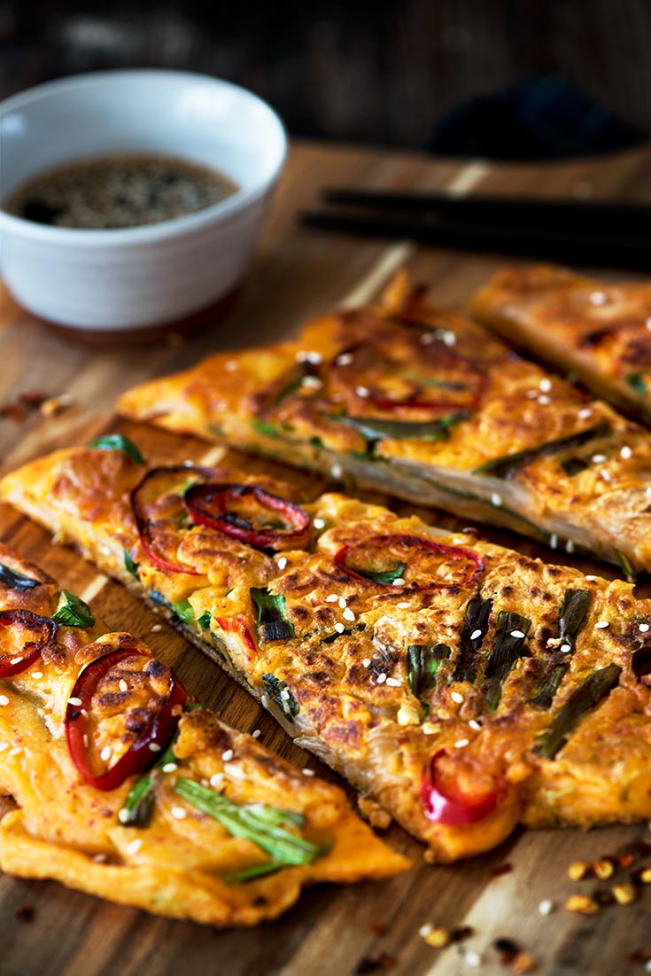 Savory Kimchi Pancake - The perfect appetizer or snack. Crispy outside, light & fluffy inside with delicious kimchi in each bite. Find out the trick to making it crisp, light & fluffy.