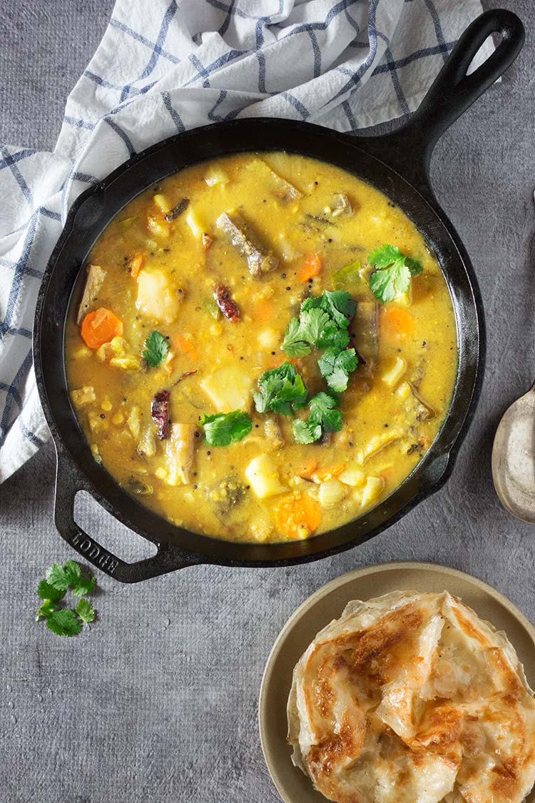 Flavor packed hearty & healthy South Indian lentil based curry stew filled with vegetables. It's mildly spicy and a tad sour from the tamarind & tomatoes. 