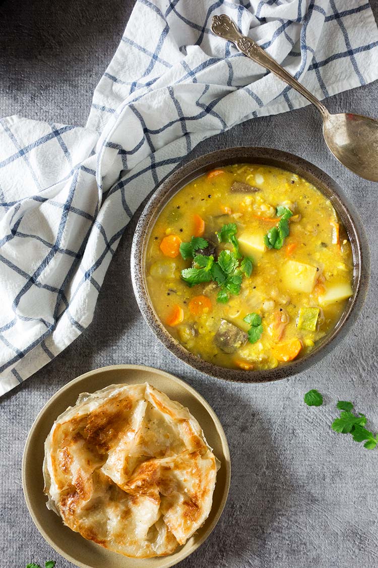 Flavor packed hearty & healthy South Indian lentil based curry stew filled with vegetables. It's mildly spicy and a tad sour from the tamarind & tomatoes. 