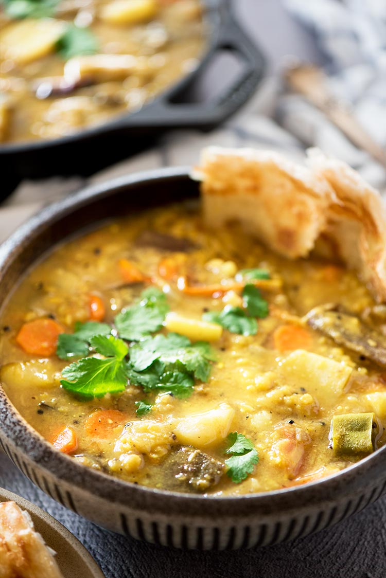 Flavor packed hearty & healthy South Indian lentil based curry stew filled with vegetables. It's mildly spicy and a tad sour from the tamarind & tomatoes. 